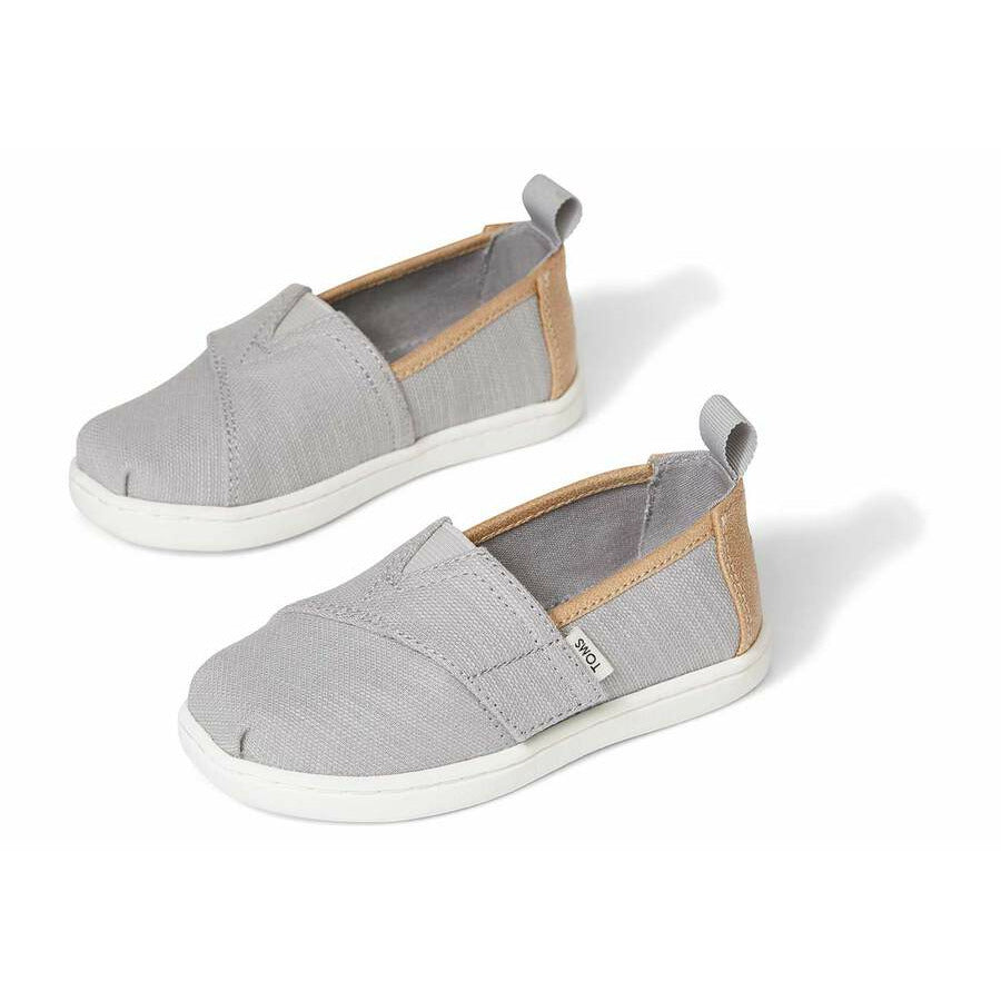 A unisex canvas shoe by TOMS, style Alpargata, in Drizzle Grey and Tan. Frontand side view of a pair.