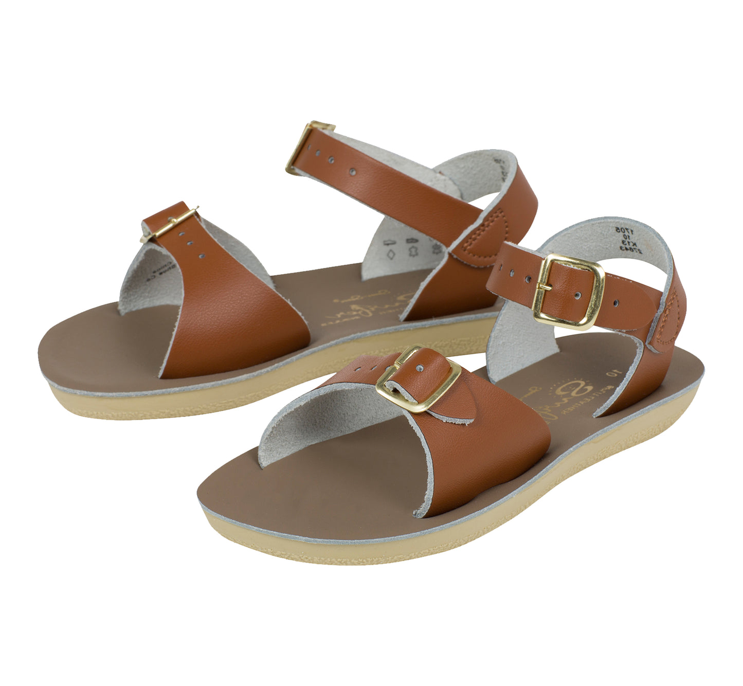 A unisex sandal by Salt Water Sandals in tan with double buckle fastening across the instep and around the ankle. Open Toe and Sling-back. Pair view.