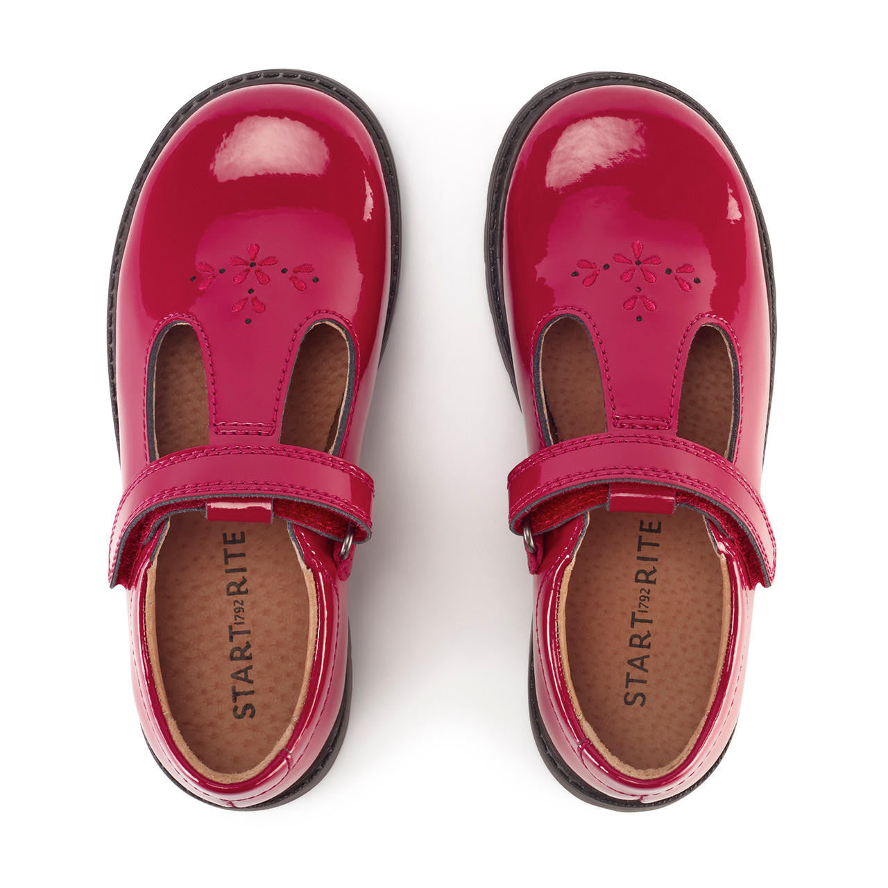 A pair of girls T-Bar shoes by Start-Rite, style Liberty, in red patent with velcro fastening. Above view.