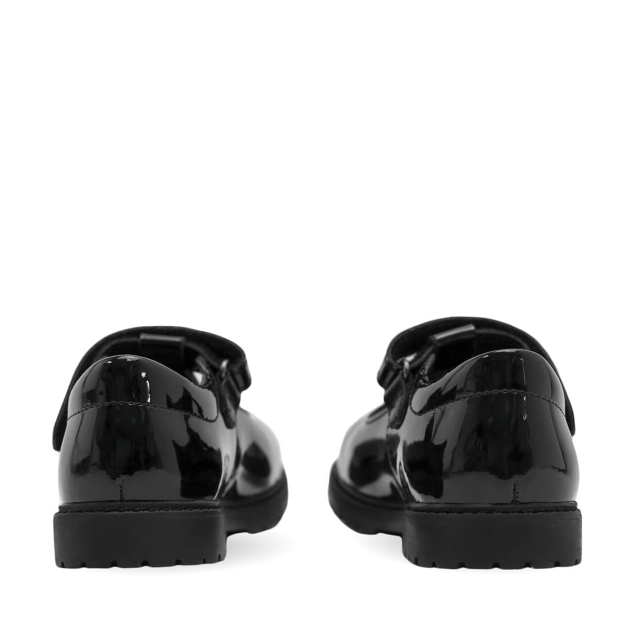 A pair of girls school shoes by Start Rite, style Liberty, in black patent with velcro fastening. Back view.