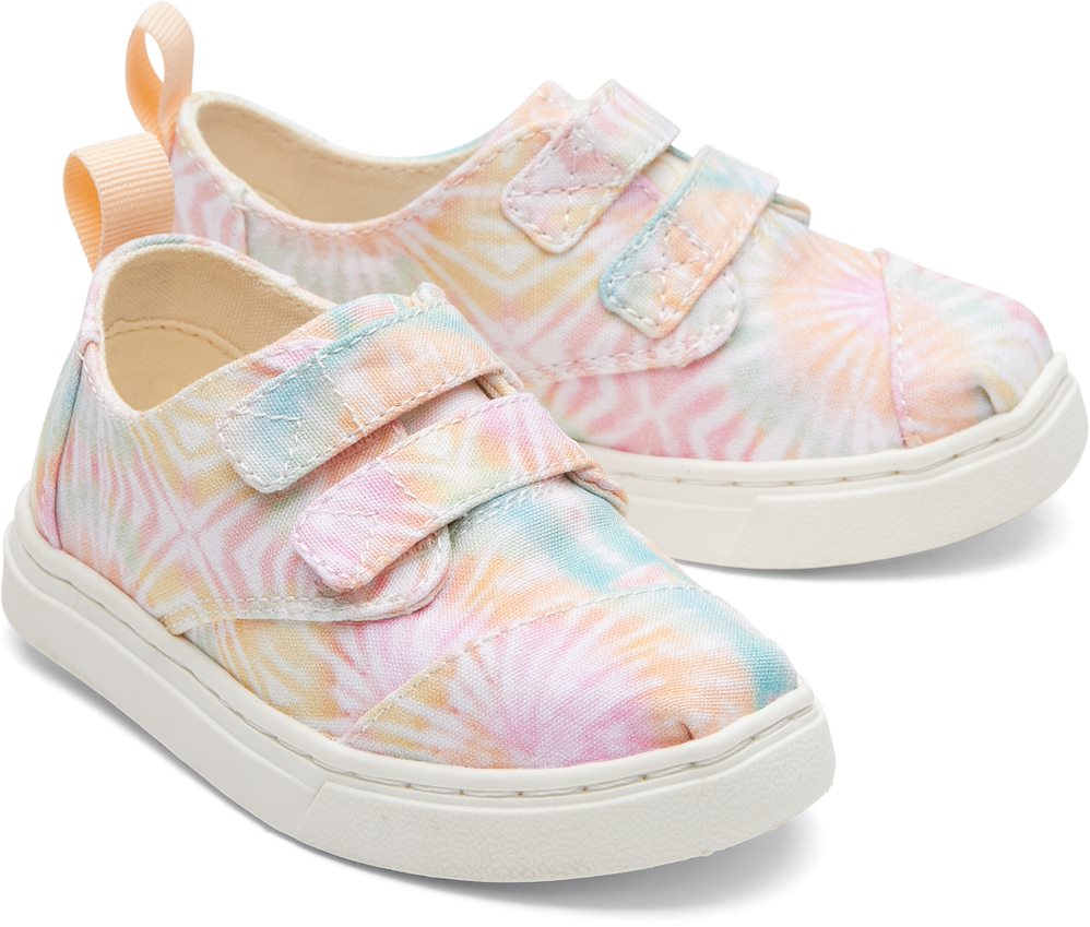 A girls canvas shoe by TOMS, style Cordones Cupsole, in Candy Pink Tie Dye with double velcro strap. Front view of a pair.
