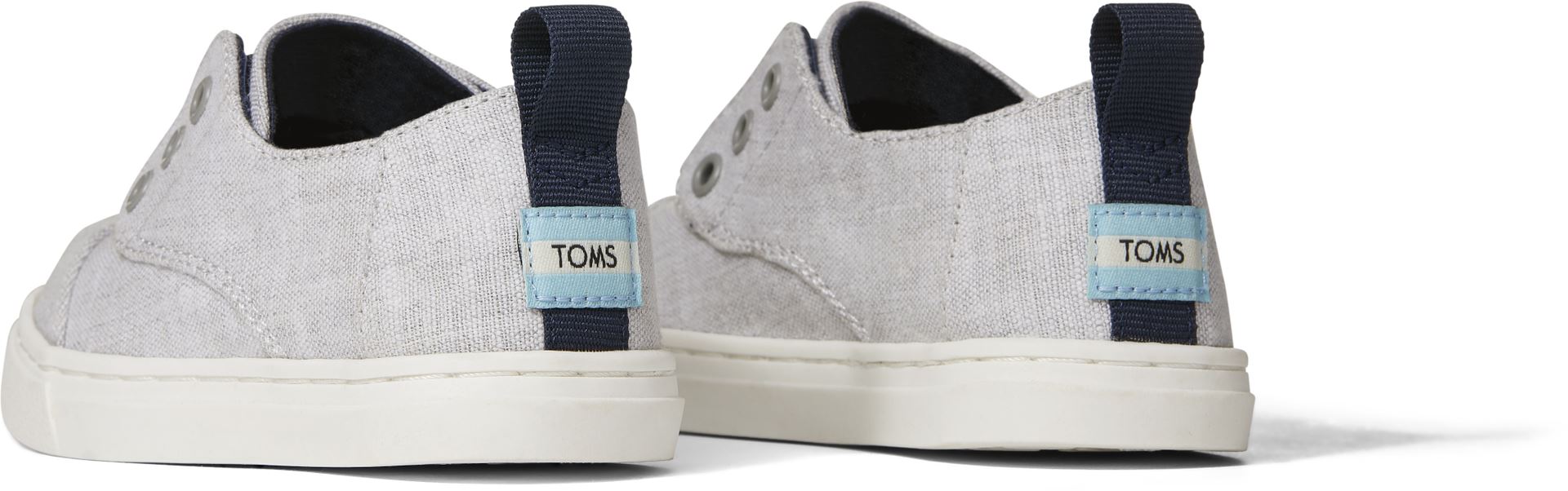 A Unisex canvas shoe by TOMS, style Cordones Cupsole, in grey with hidden velcro tabs. Back view of a pair.