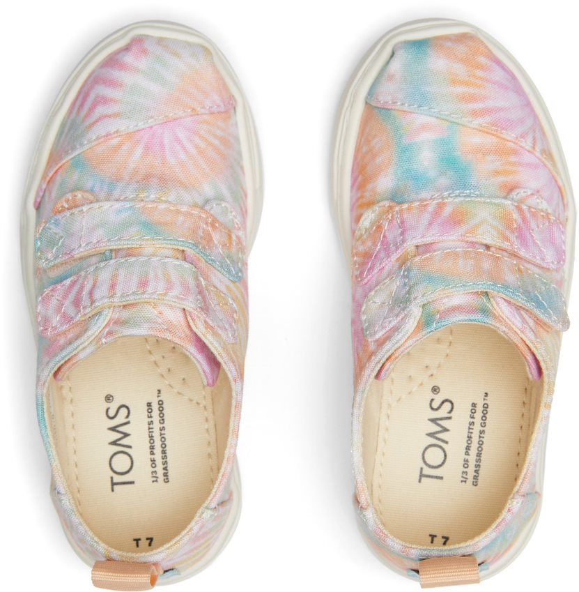 A girls canvas shoe by TOMS, style Cordones Cupsole, in Candy Pink Tie Dye with double velcro strap. Top view of a pair.