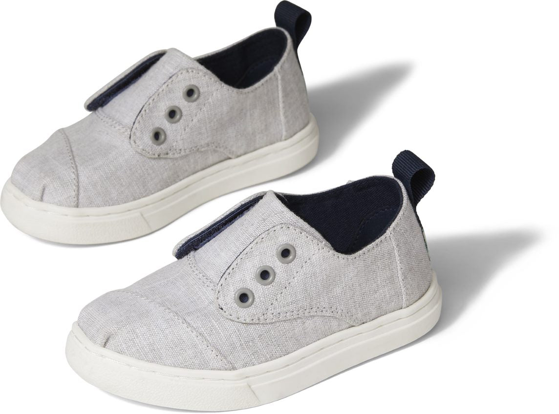 A unisex canvas shoe by TOMS, style Cordones Cupsole, in grey with hidden velcro tabs. Front and side view of a pair.