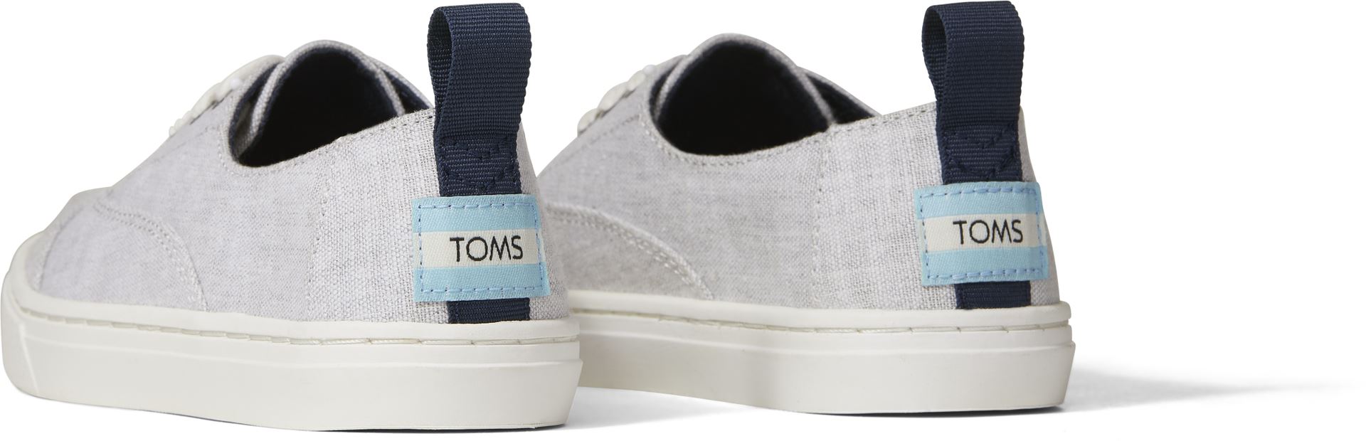 A unisex canvas shoe by TOMS, style Cordones Cupsole, a lace-up in grey. Back view of a pair.