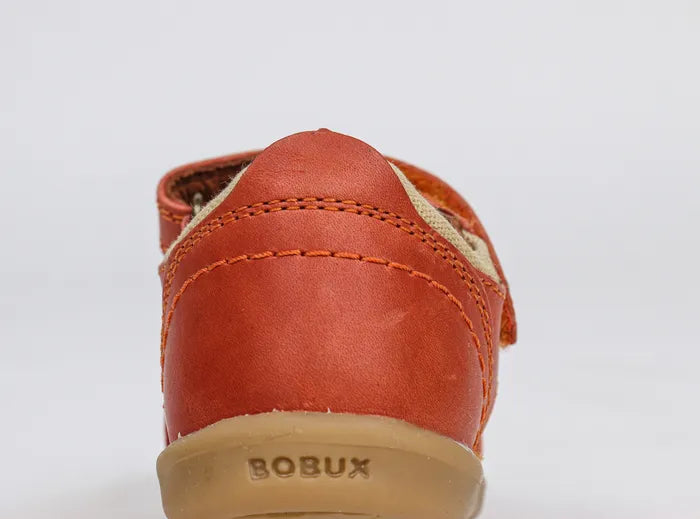A boys closed toe sandal by Bobux,style Roam,in orange with velcro fastening. Back view.