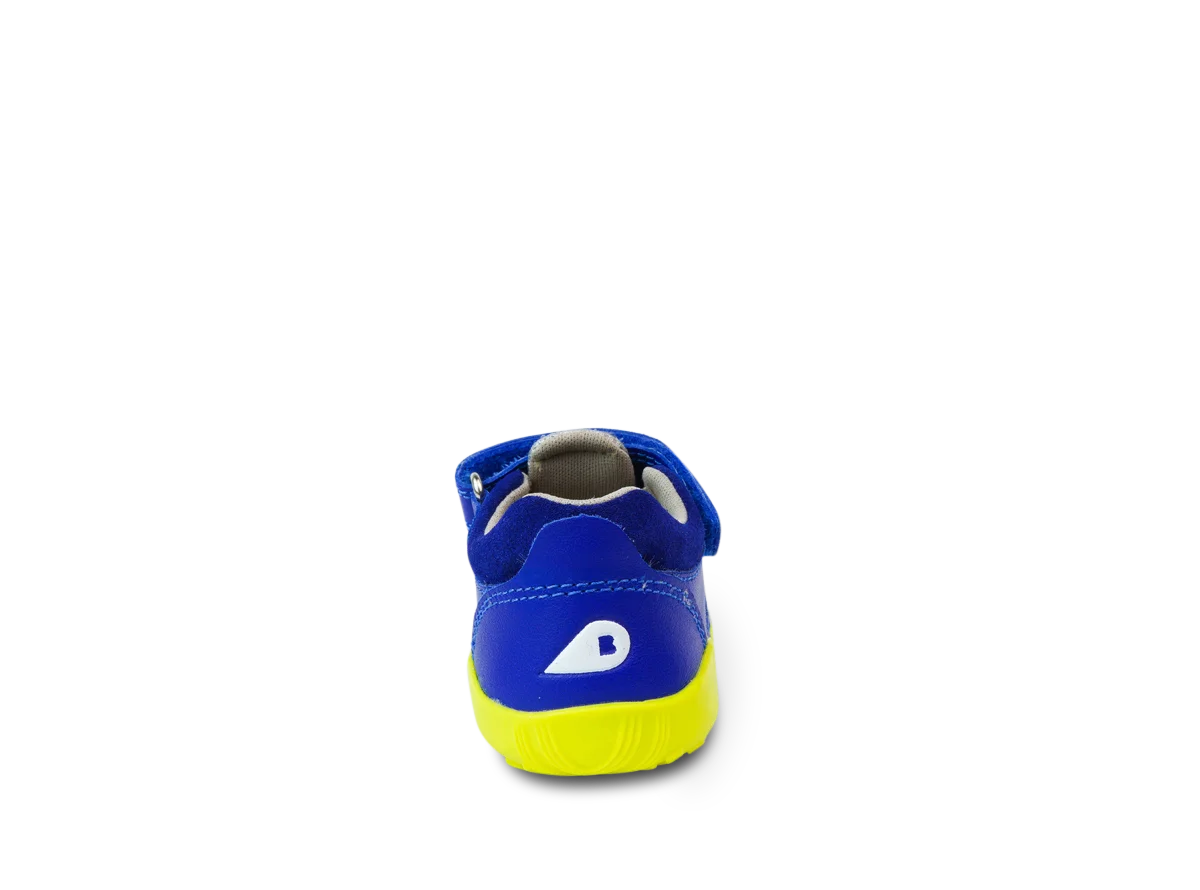 A unisex sandal by Bobux, style Summit,in blue leather/microfibre with neon yellow sole and trim and velcro/elastic fastening. Back view.