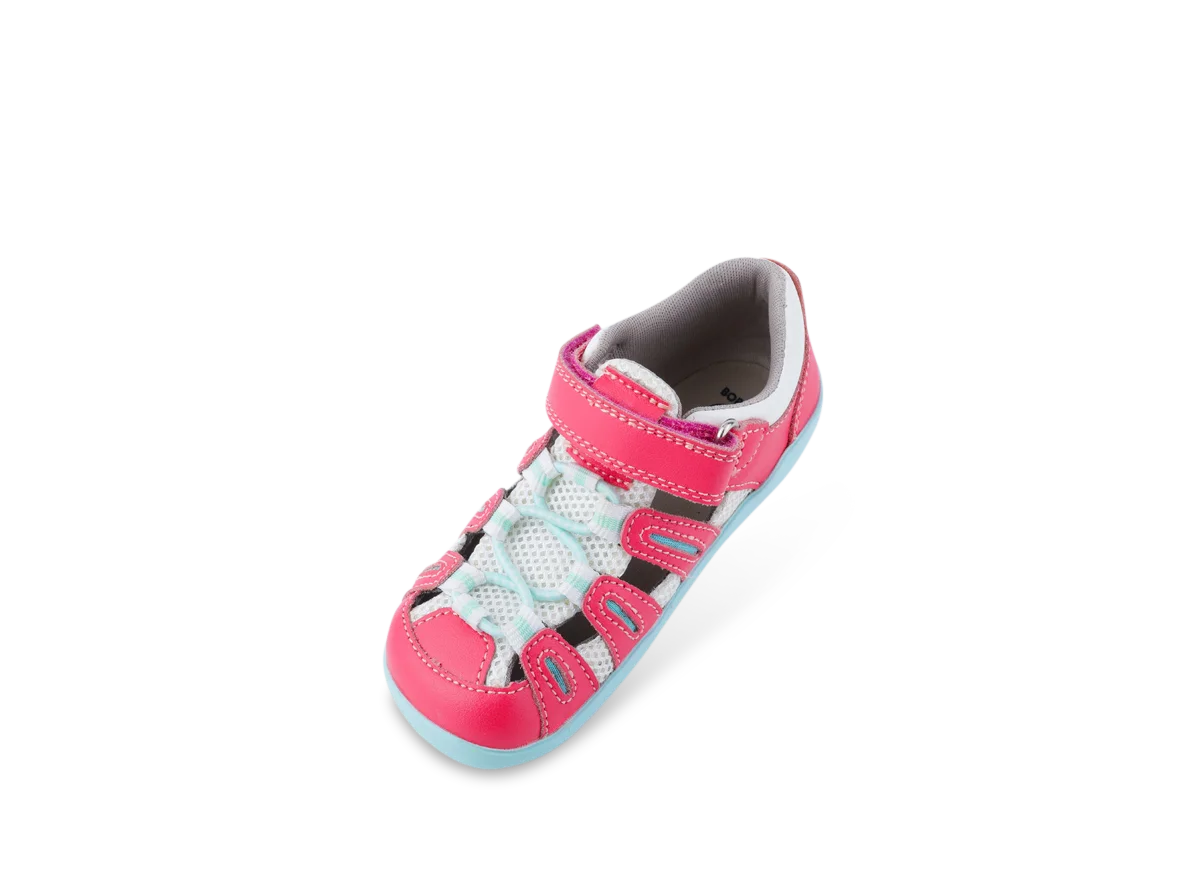 A girls closed toe sandal by Bobux, style Summit,in pink leather/microfibre with pale blue sole and trim and velcro/elastic fastening. Angled view.