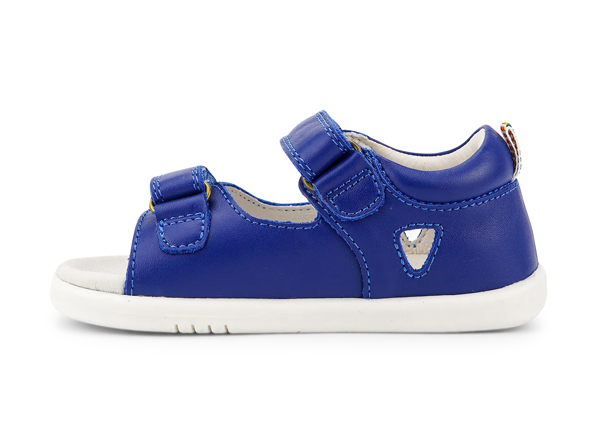 A boys open toe sandal by Bobux, style Rise, in Blue leather with velcro fastening. Left side view.