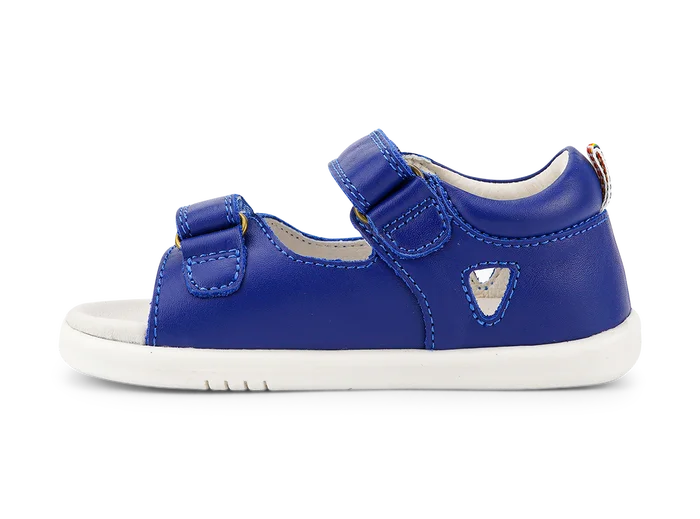 A boys open toe sandal by Bobux, style Rise in Blue leather with velcro fastening. Left side view.