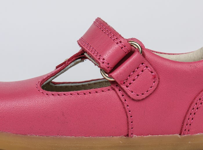 A girls Mary Jane shoe by Bobux,style Louise,in bright pink with velcro fastening. Inner side view.