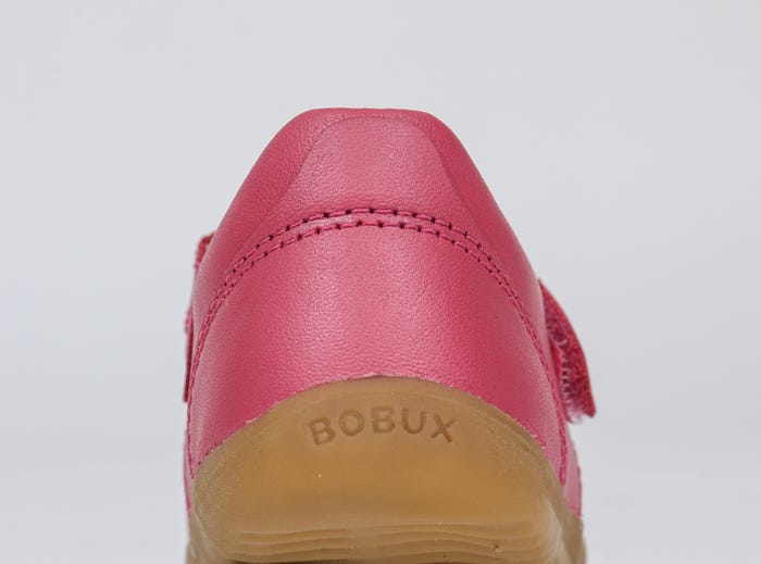 A girls Mary Jane shoe by Bobux,style Louise,in bright pink with velcro fastening. Back view.