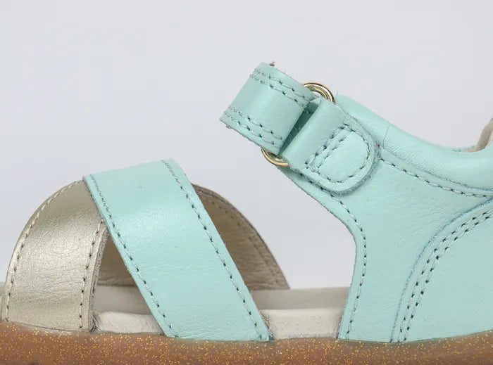 A girls open toe sandal by Bobux, style Sail, in mint and gold with velcro fastening. Inner view.