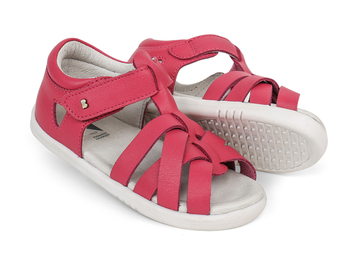 A pair of girls open toe sandals by Bobux, style Tropicana in bright pink with velcro fastening. Right side view.