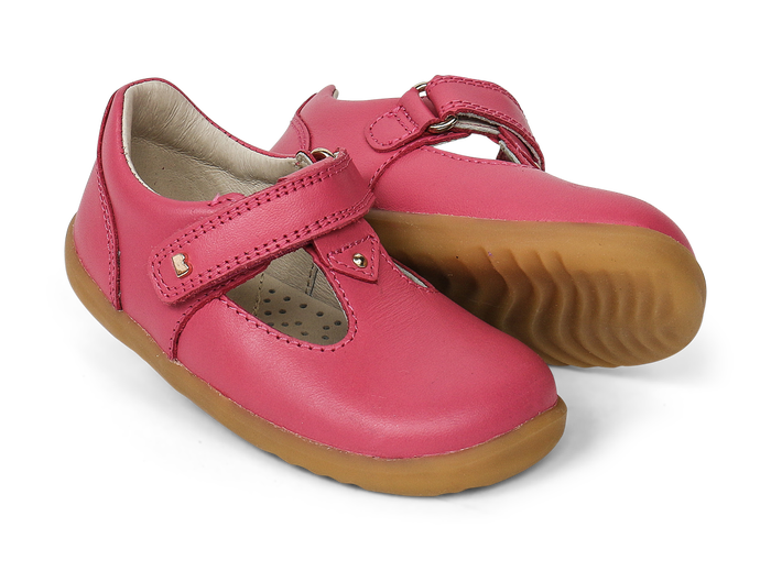 A pair of girls Mary Jane shoes by Bobux,style Louise,in bright pink with velcro fastening. Right side view.