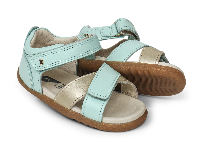 A pair of girls open toe sandals by Bobux, style Sail, in mint and gold with velcro fastening. Right side view.