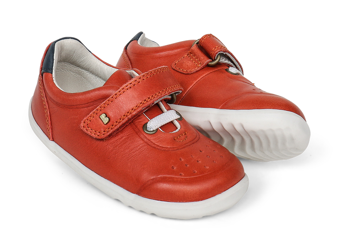 A pair of boys smart trainers by Bobux,style Ryder, in orange and navy with velcro fastening. Right side view.