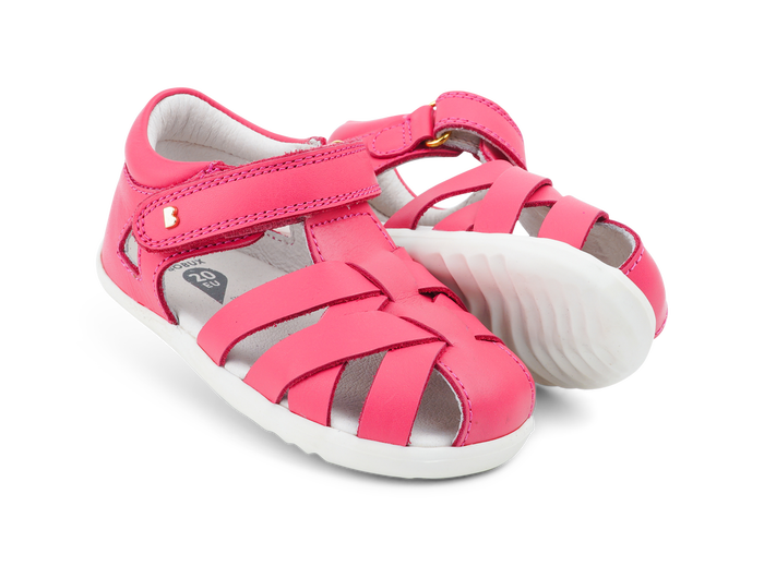 A pair of girls open toe sandals by Bobux, style Tropicana in bright pink with velcro fastening. Right side view.