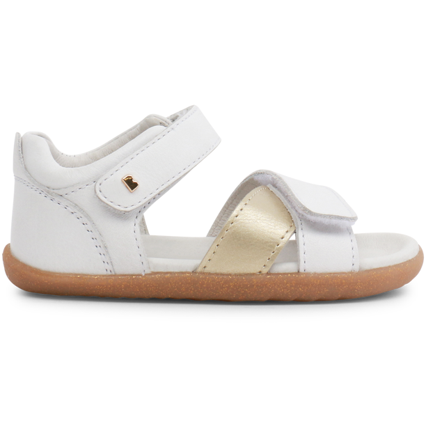 A girls open toe sandal by Bobux, style Sail, in white and gold with velcro fastening. Right side view.