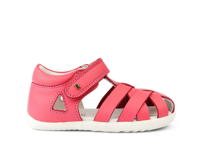 A girls open toe sandal by Bobux, style Tropicana in bright pink with velcro fastening. Right side view.