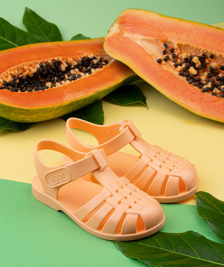 A pair of unisex closed toe sandals by Igor,style Clasica, pastel orange with velcro fastening. Right side view.