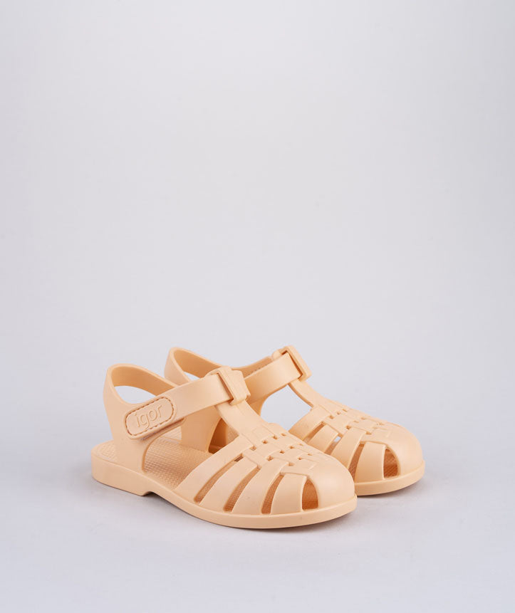 A pair of unisex closed toe sandal by Igor,style Clasica, pastel orange with velcro fastening. Right side view.