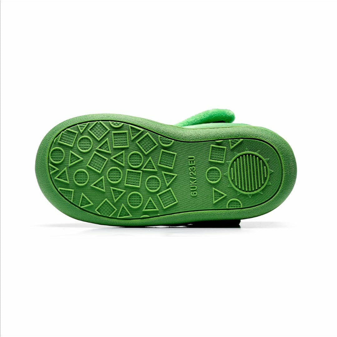 A unisex slipper by Chipmunks, style Scorch in green with dinosaur face. Sole view.