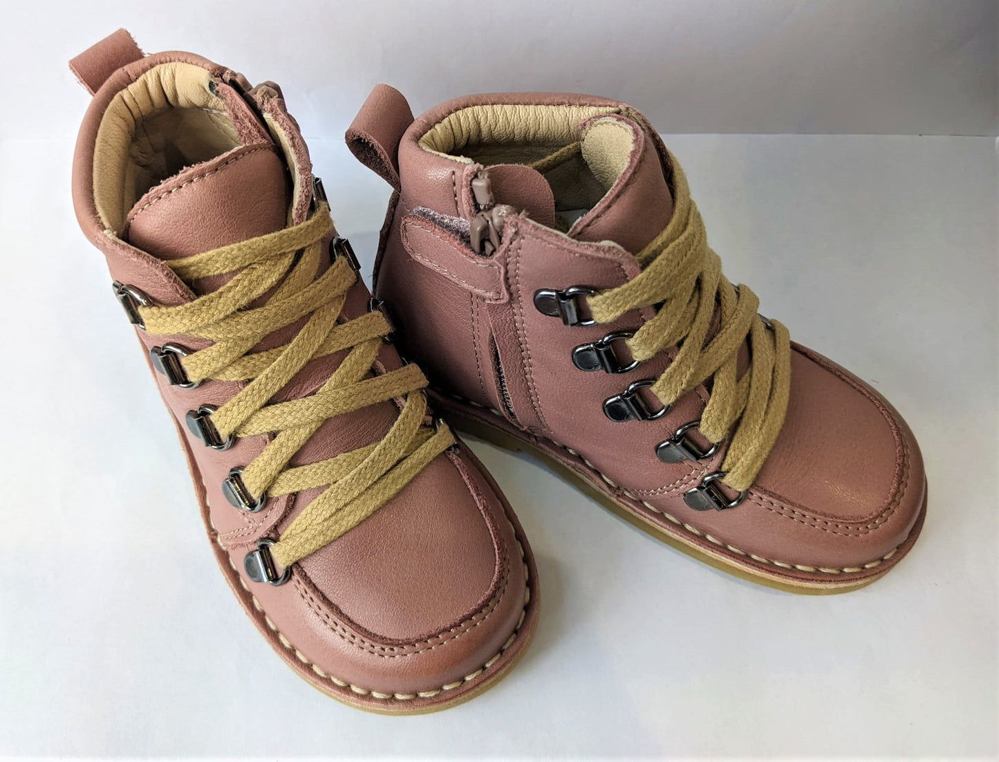 A girls lace up  boot by Petasil, style Kent, in pink leather with lace and zip fastening. Top view showing a pair.