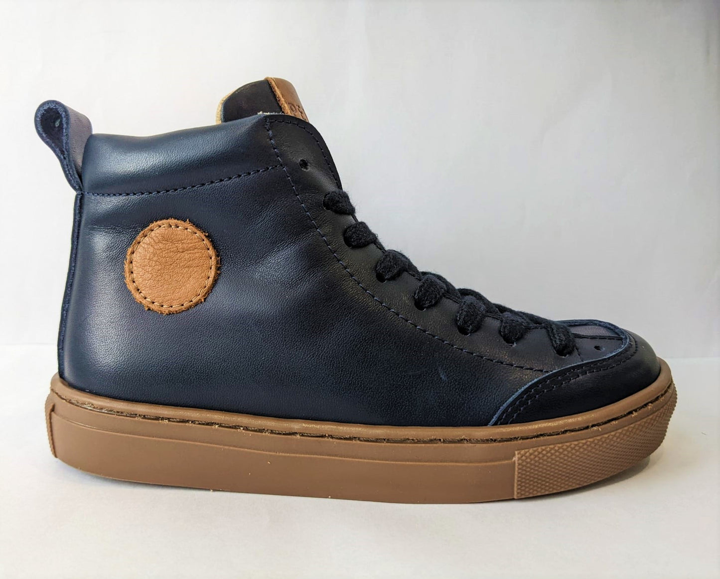 A boys boot by Petasil, style Esme, in navy with lace and side zip fastening. Right side view.