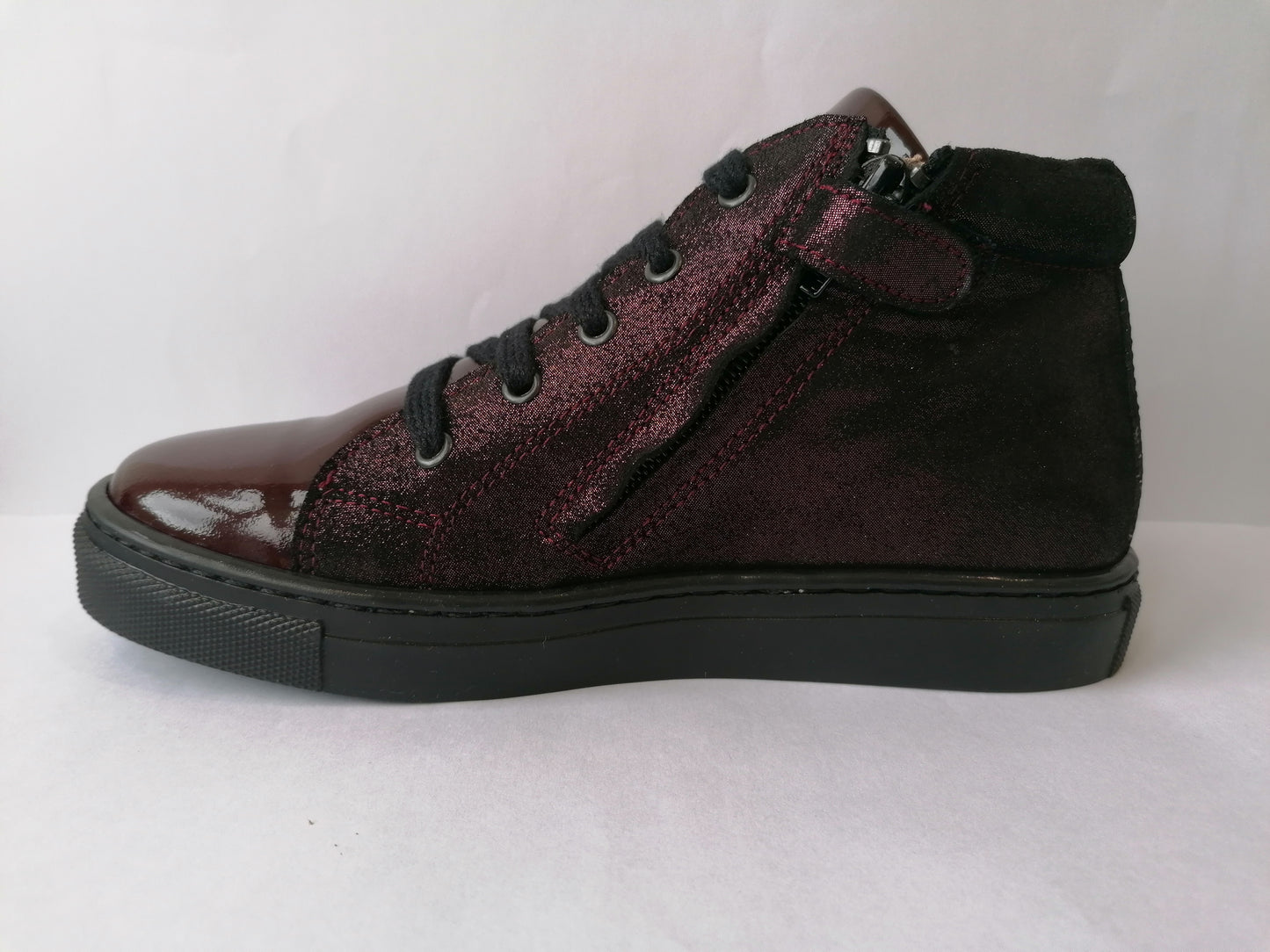 A girls casual boot by Petasil, style Gracie 2, in burgundy patent and glitter nubuck with lace and zip fastening. Left side view.