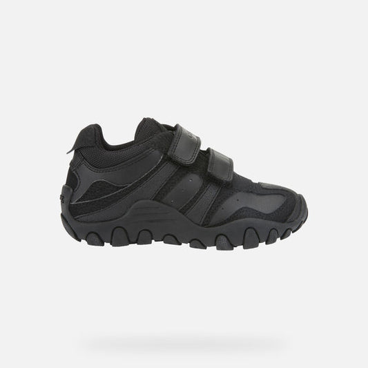 A boys black trainer by Geox, style Crush, in black with double velcro fastening. Right side view.