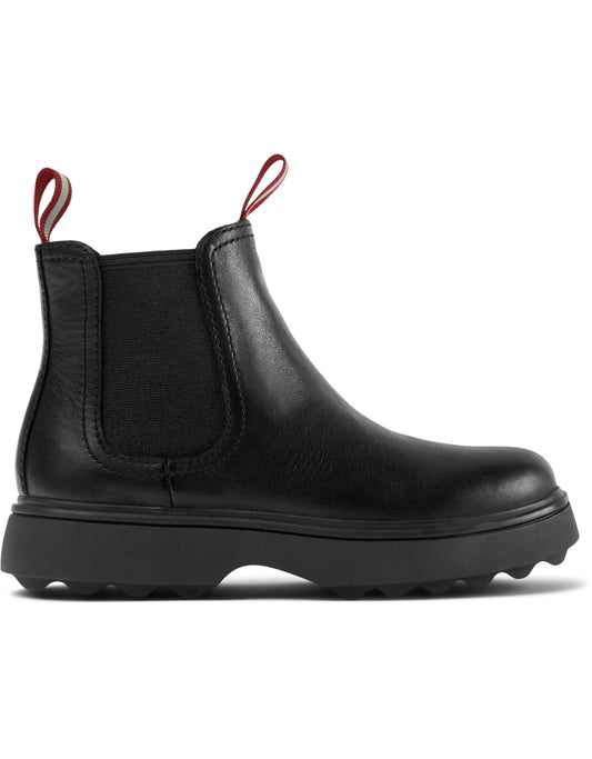 A girls chelsea boot by Camper, style K900149-001,in black leather,pull on style. Right side view.
