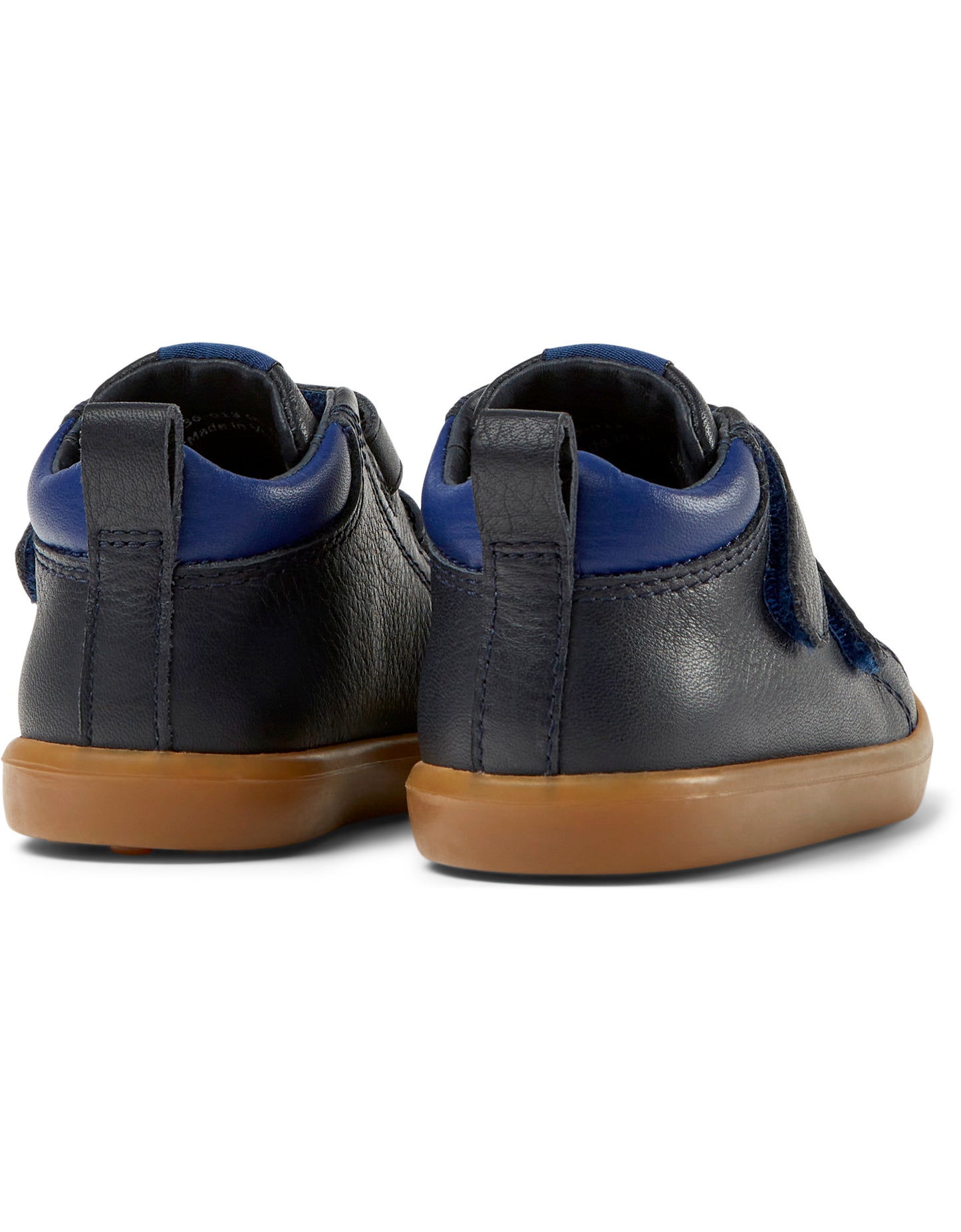 A pair of boys casual ankle boots by Camper, style K900236-013 in navy and blue leather with double velcro fastening. Angled view.