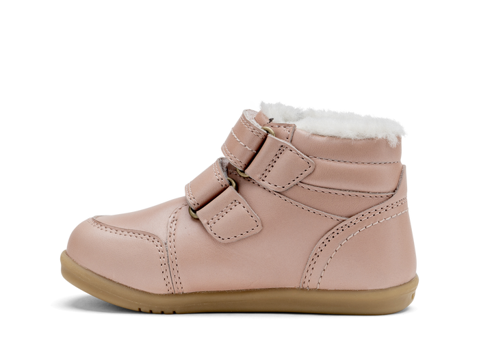 A girls waterproof fur lined ankle boot by Bobux,style Timber, in pale pink with double velcro fastening. Left side view.