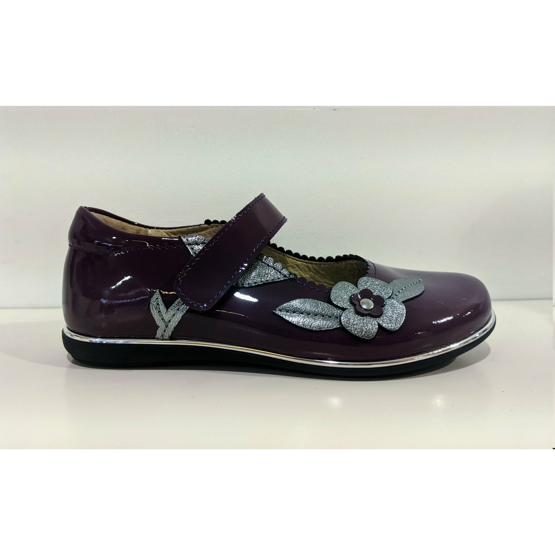 A girls Mary Jane shoe by Petasil,style Caren, in purple patent and silver with velcro fastening. Right side view.