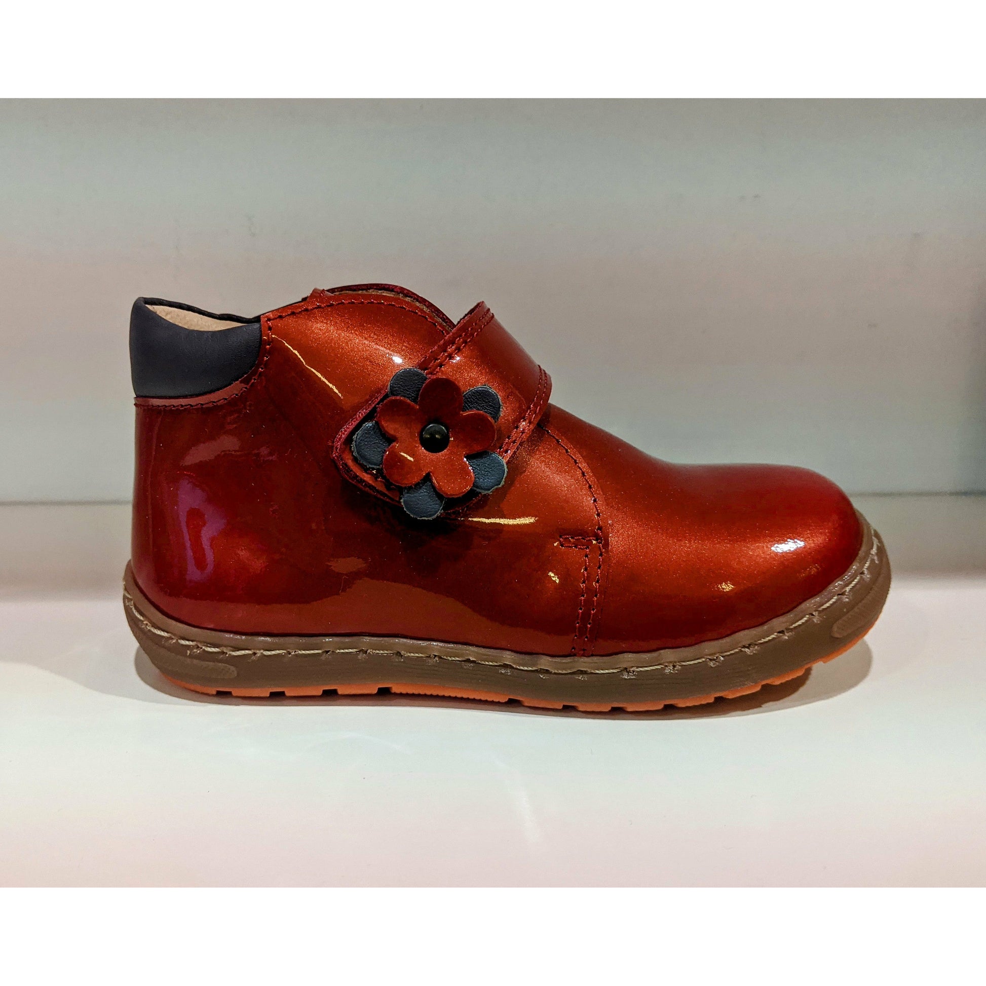 A girls ankle boot by Petasil, style Denise, in Red patent with velcro fastening. Right side view