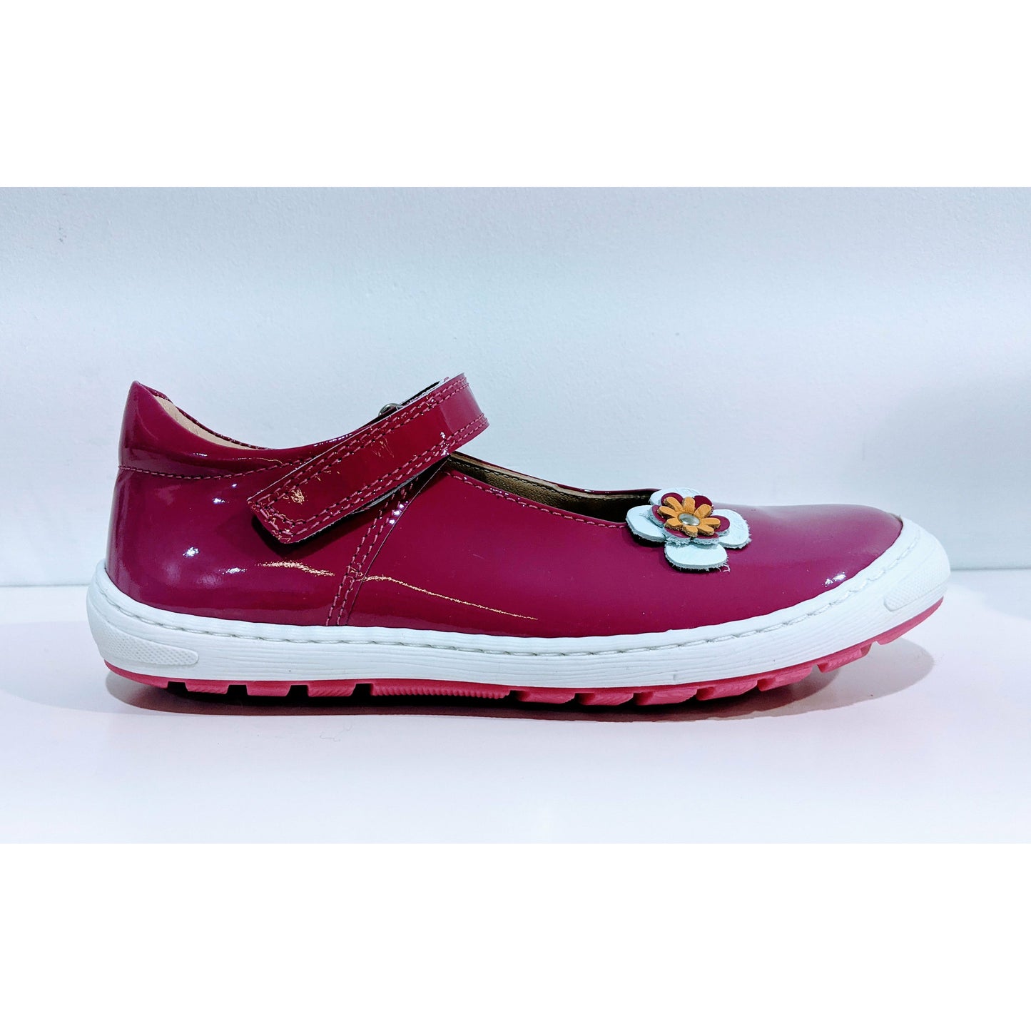 A girls Mary Jane shoe by Petasil,style Cathy, in pink patent with velcro fastening. Right side view.