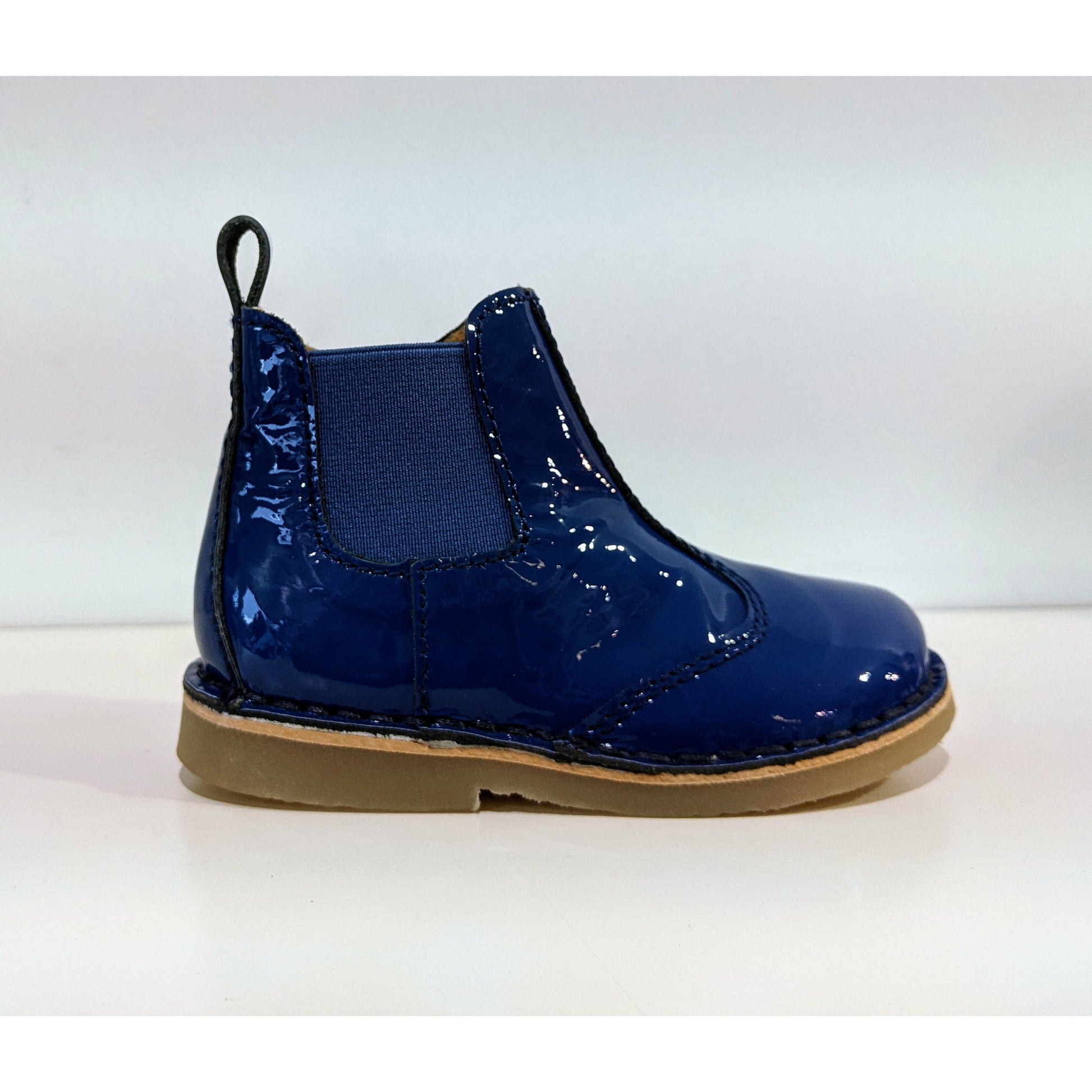 A girls chelsea boot by Petasil,style Keel,in blue patent with zip fastening. Right side view.
