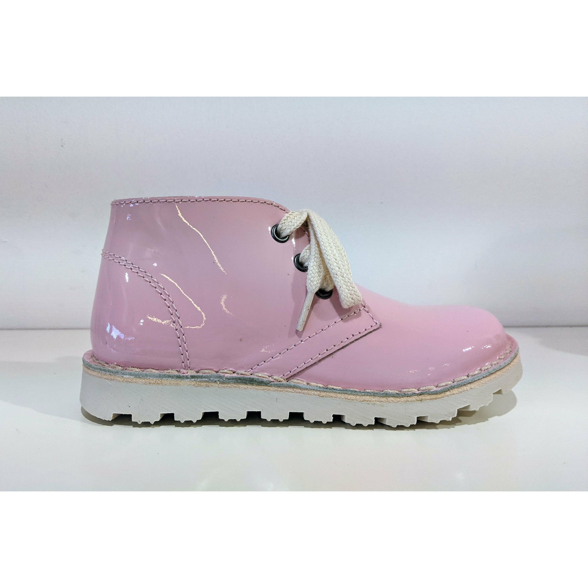 A girls ankle boot by Petasil, style Kip, in pink with lace up fastening. Right side view.