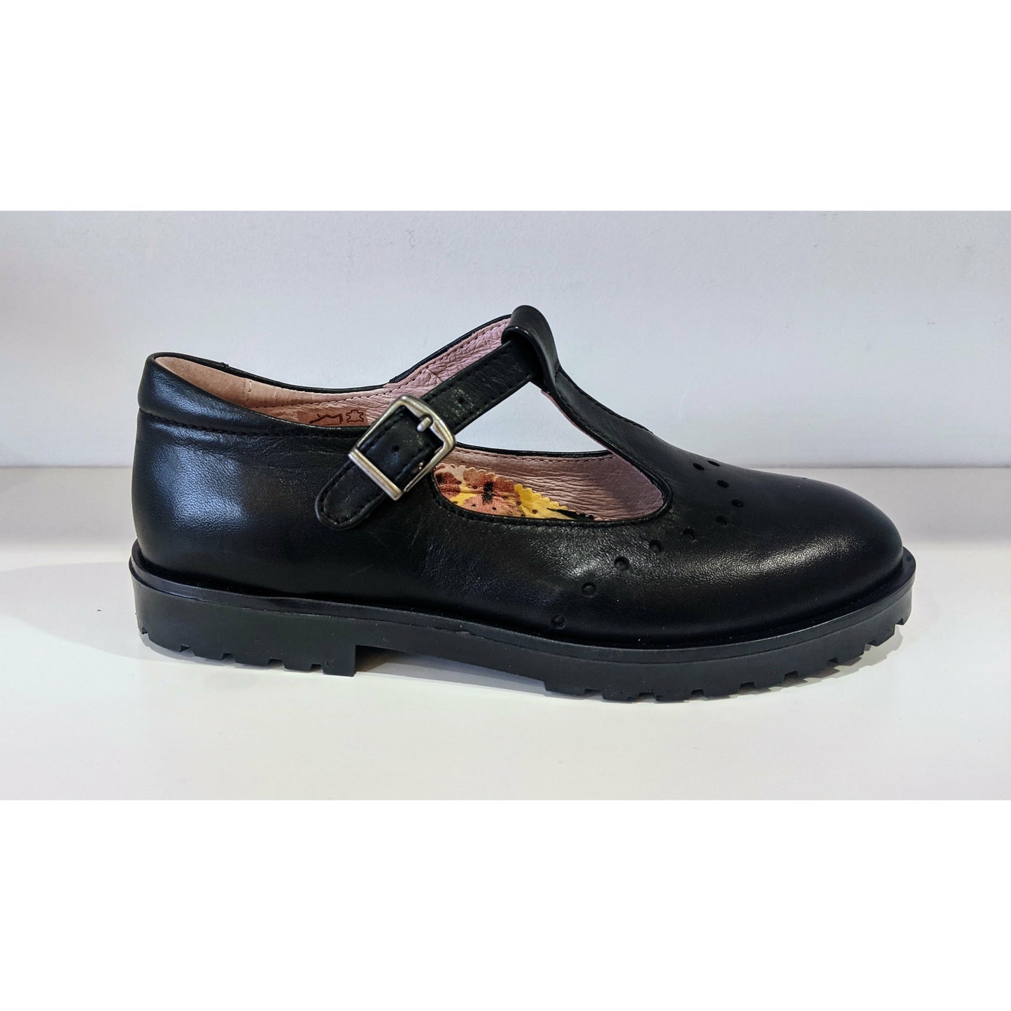 A girls T-Bar school shoe by Petasil, style Tangier, in black with buckle fastening. Right side view.