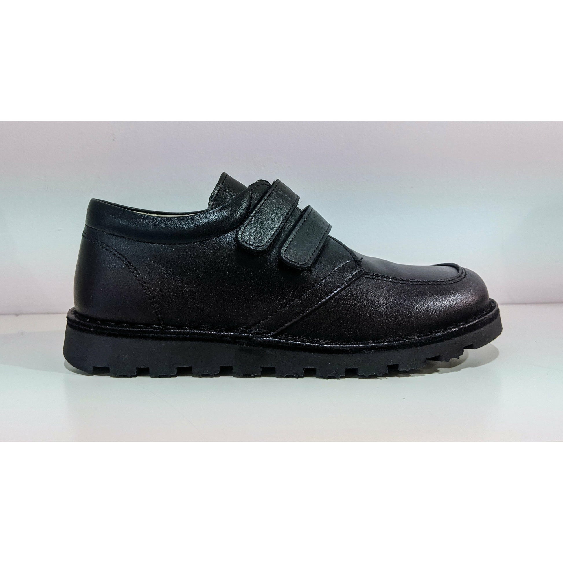 A boys smart school shoe by Petasil, style Celestino, in black with double velcro fastening. Right side view.