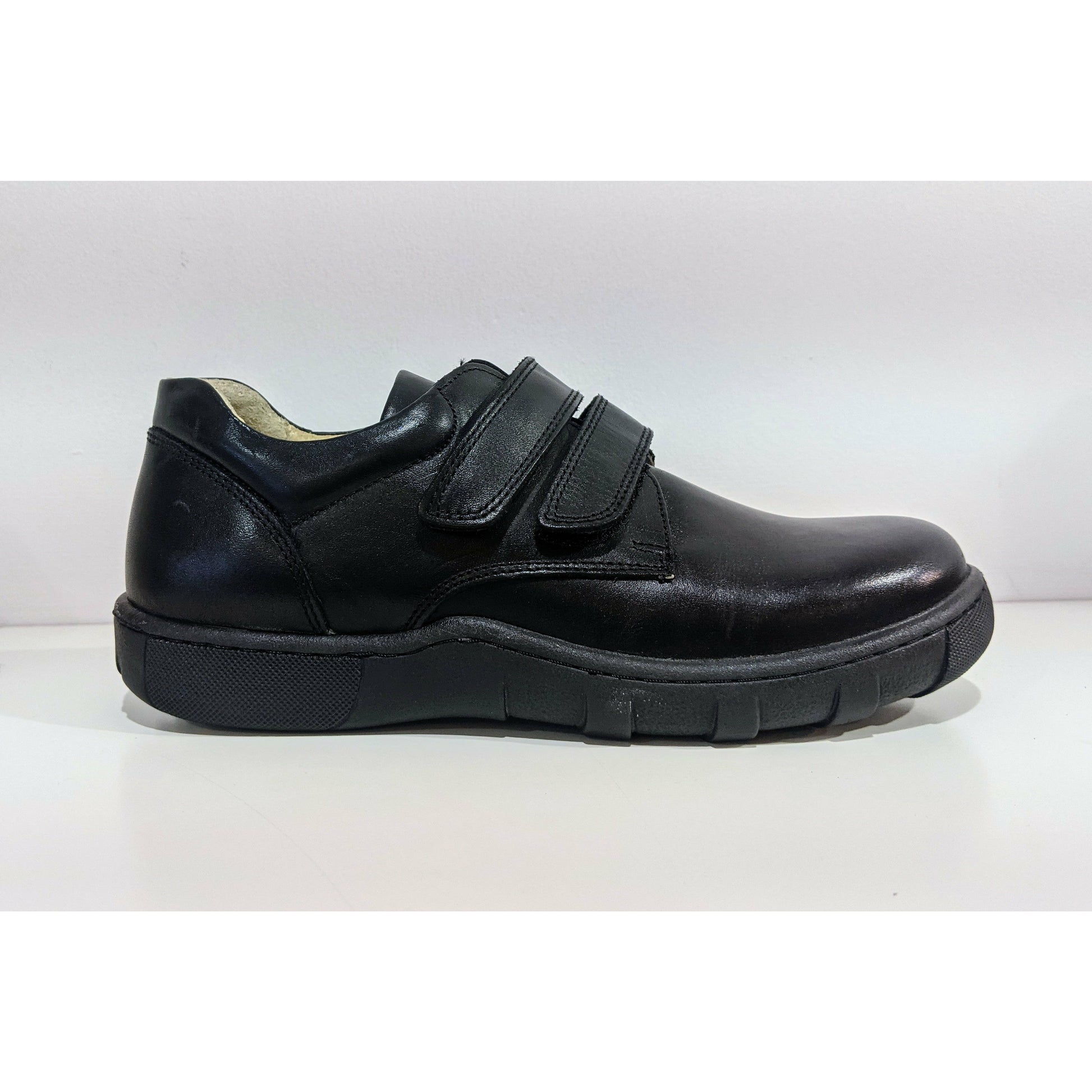 A boys smart school shoe by Petasil, style Patrick, in black with double velcro fastening. Right side view.