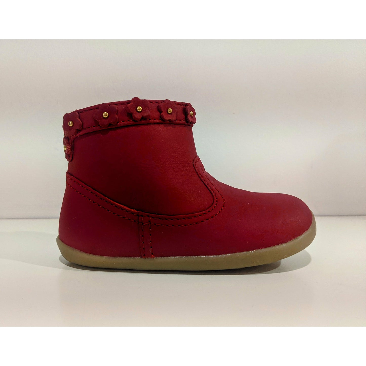 A girls ankle boot by Bobux, style Escape, in red with red and gold flowers. Right side view.