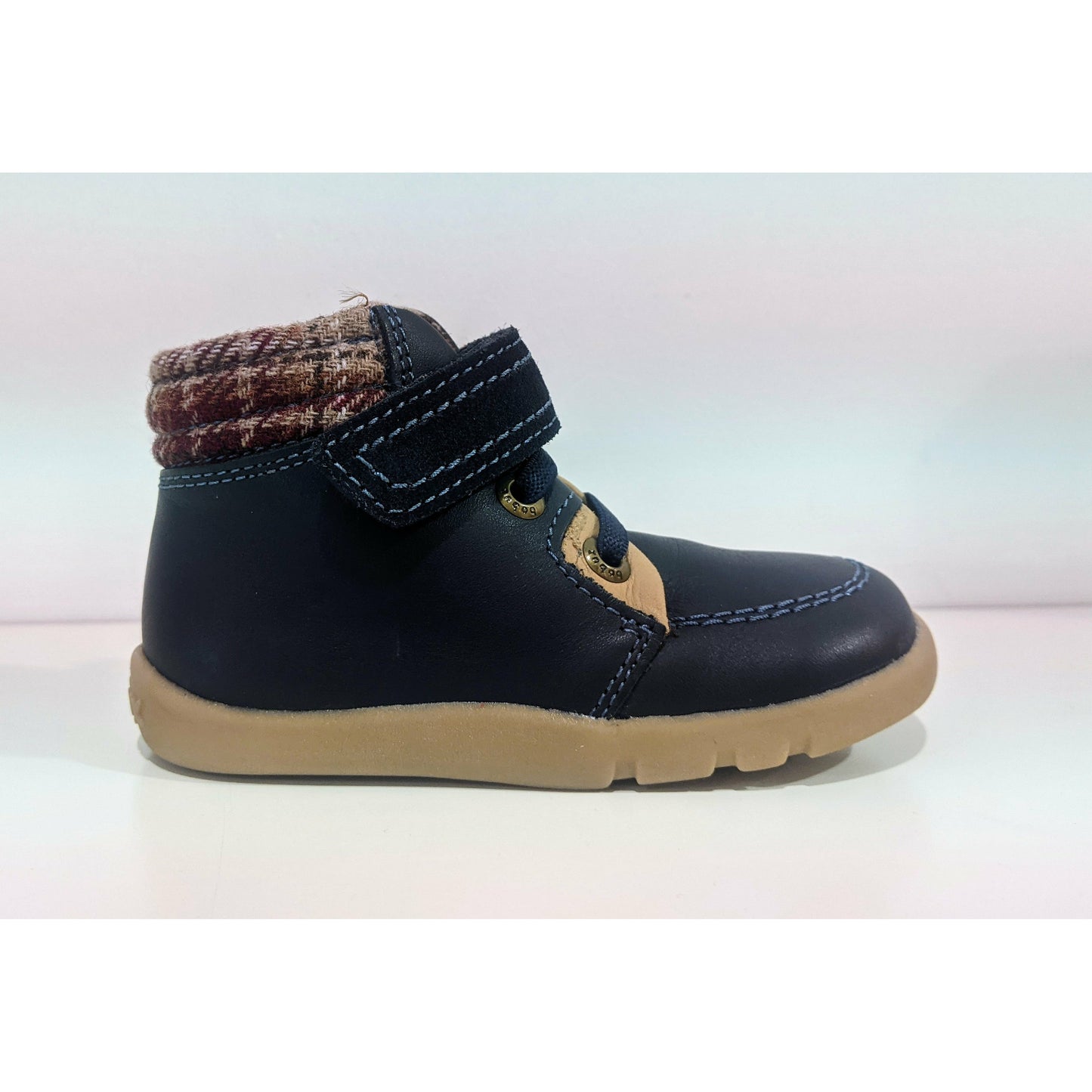 A boys ankle boot by Bobux. style Little Lumberjack, in Navy with velcro fastening. Right side view.