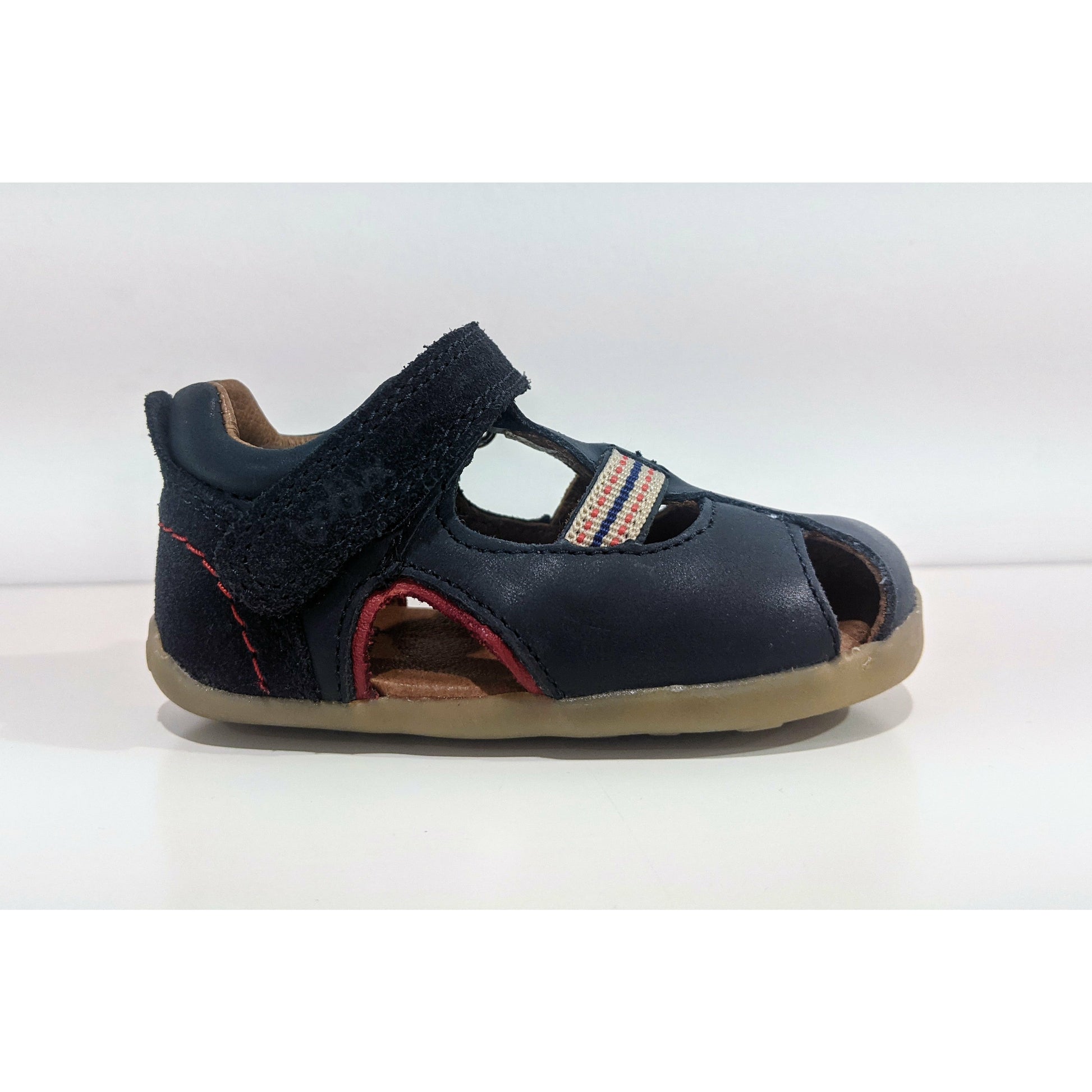 A boys closed toe sandal by Bobux,in Navywith velcro fastening. Right side view.