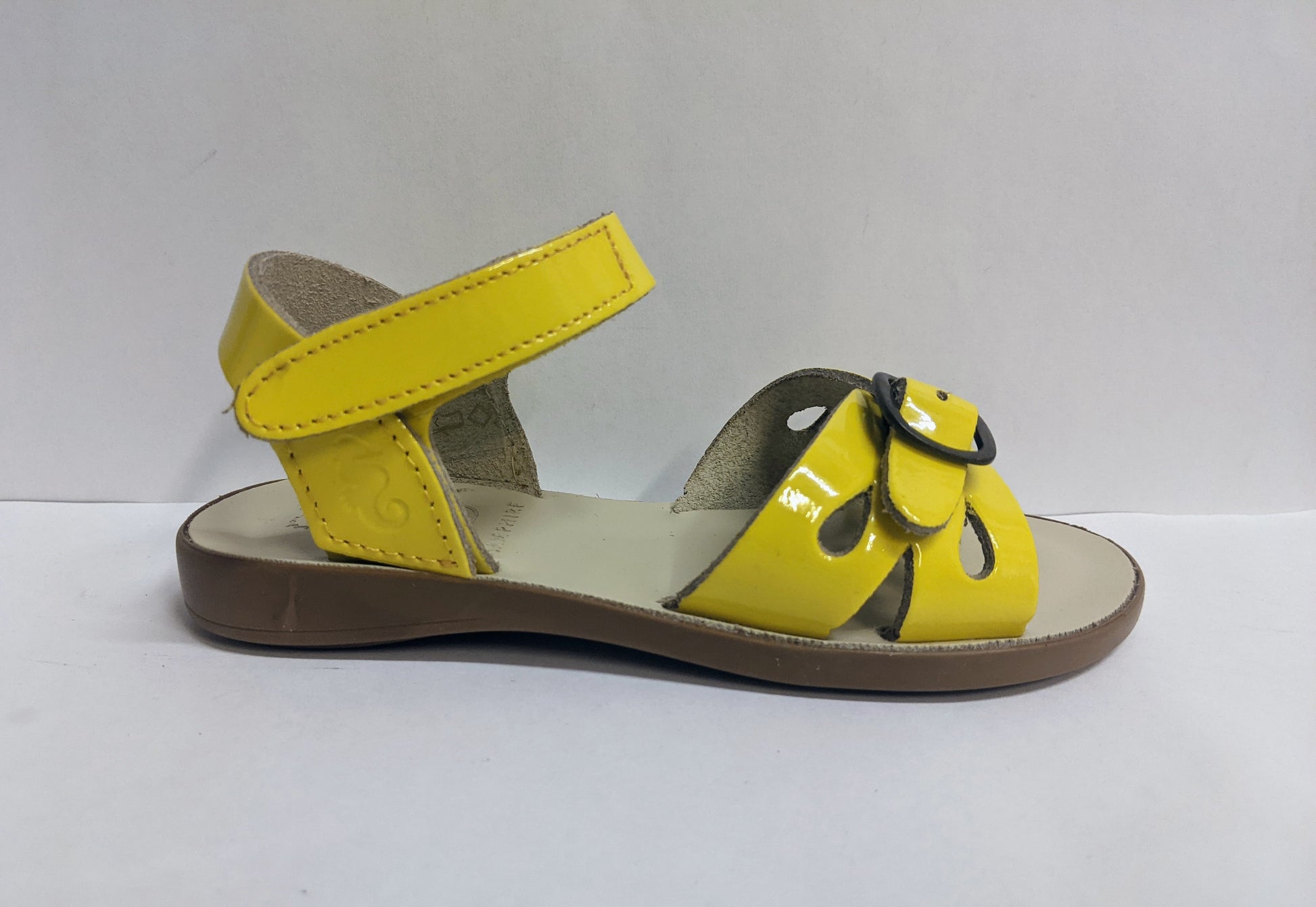 A girls sandal by Petasil Samphire, style Marella 2, in yellow patent with velcro fastening. Right side view.