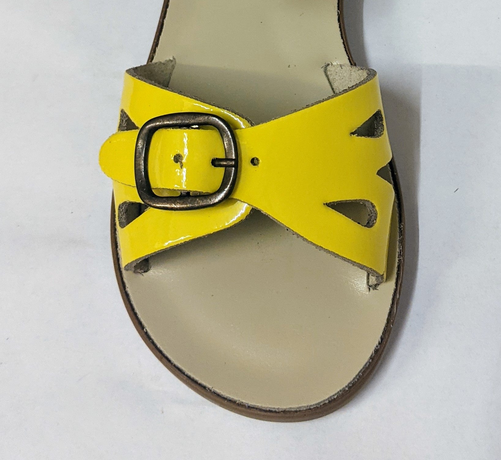 A girls sandal by Petasil Samphire, style Marella 2, in yellow patent with velcro fastening.  Above view.