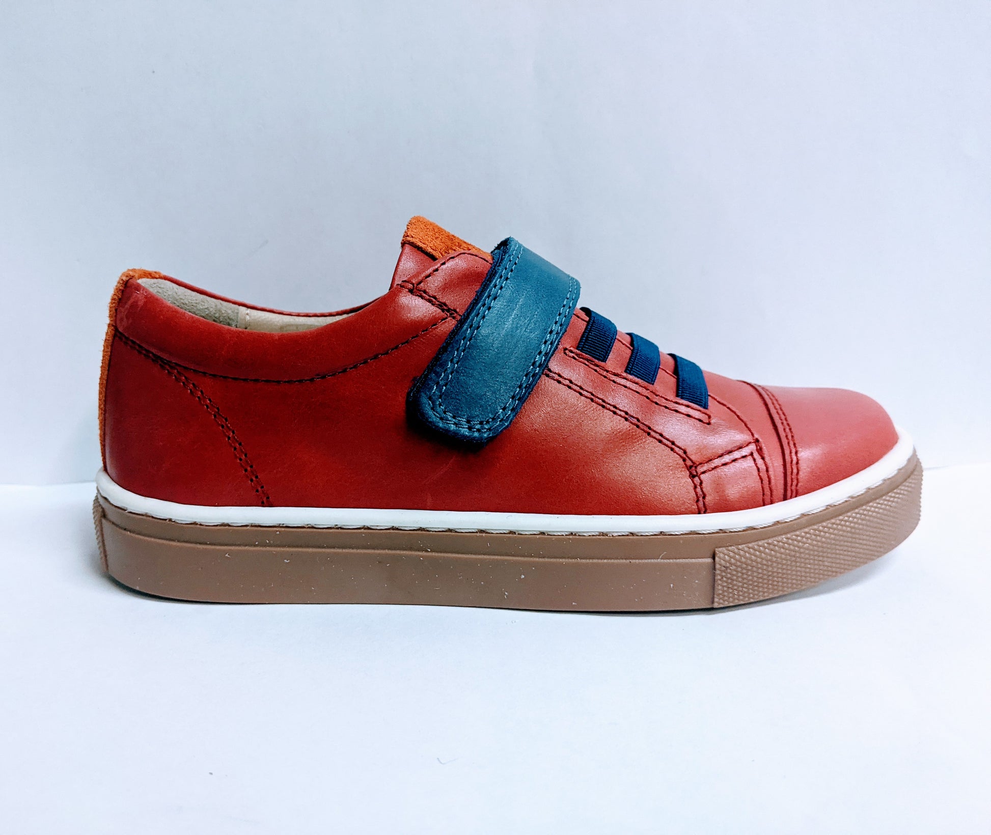 A boys smart trainer by Petasil, style Ryan 2, in red and blue with velcro fastening. Right side view.