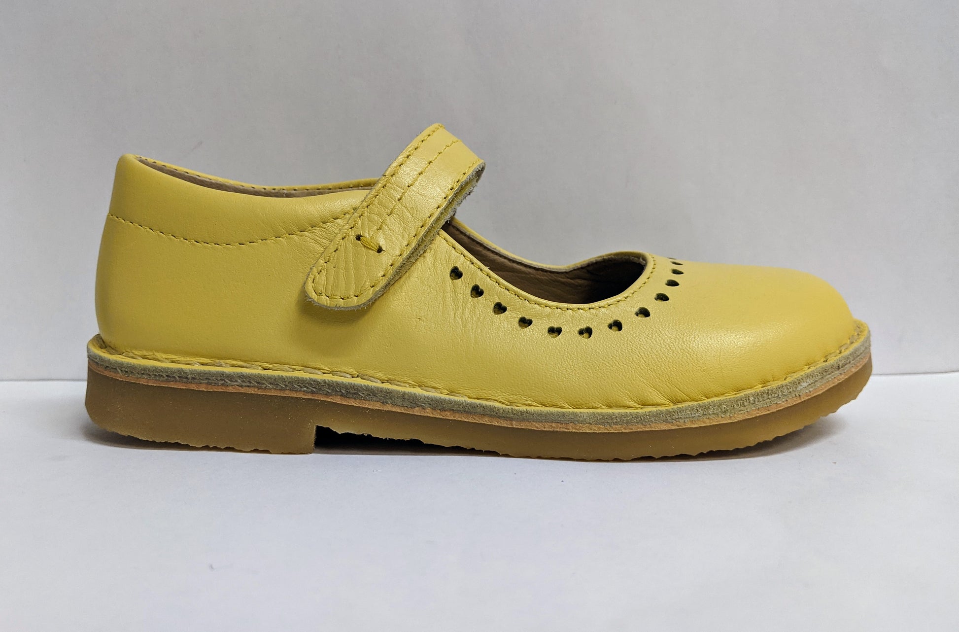 A girls Mary Jane shoe by Petasil,style Nadia, in yellow with velcro fastening. Right side view.