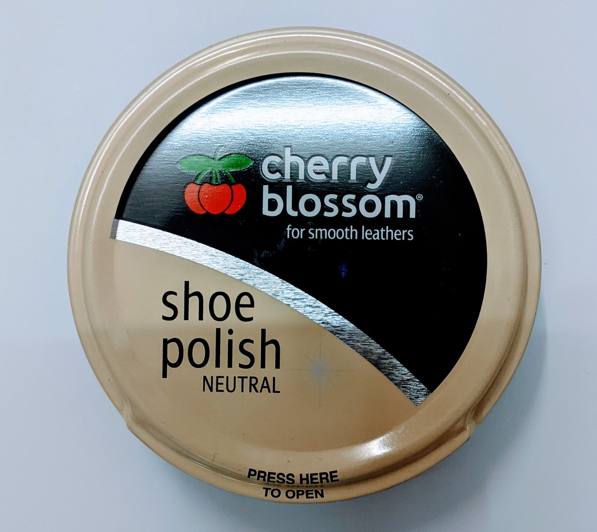 A tin of clear shoe polish by Cherry Blossom.